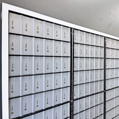 A wall of numbered private mailboxes inside Cardiff Postal