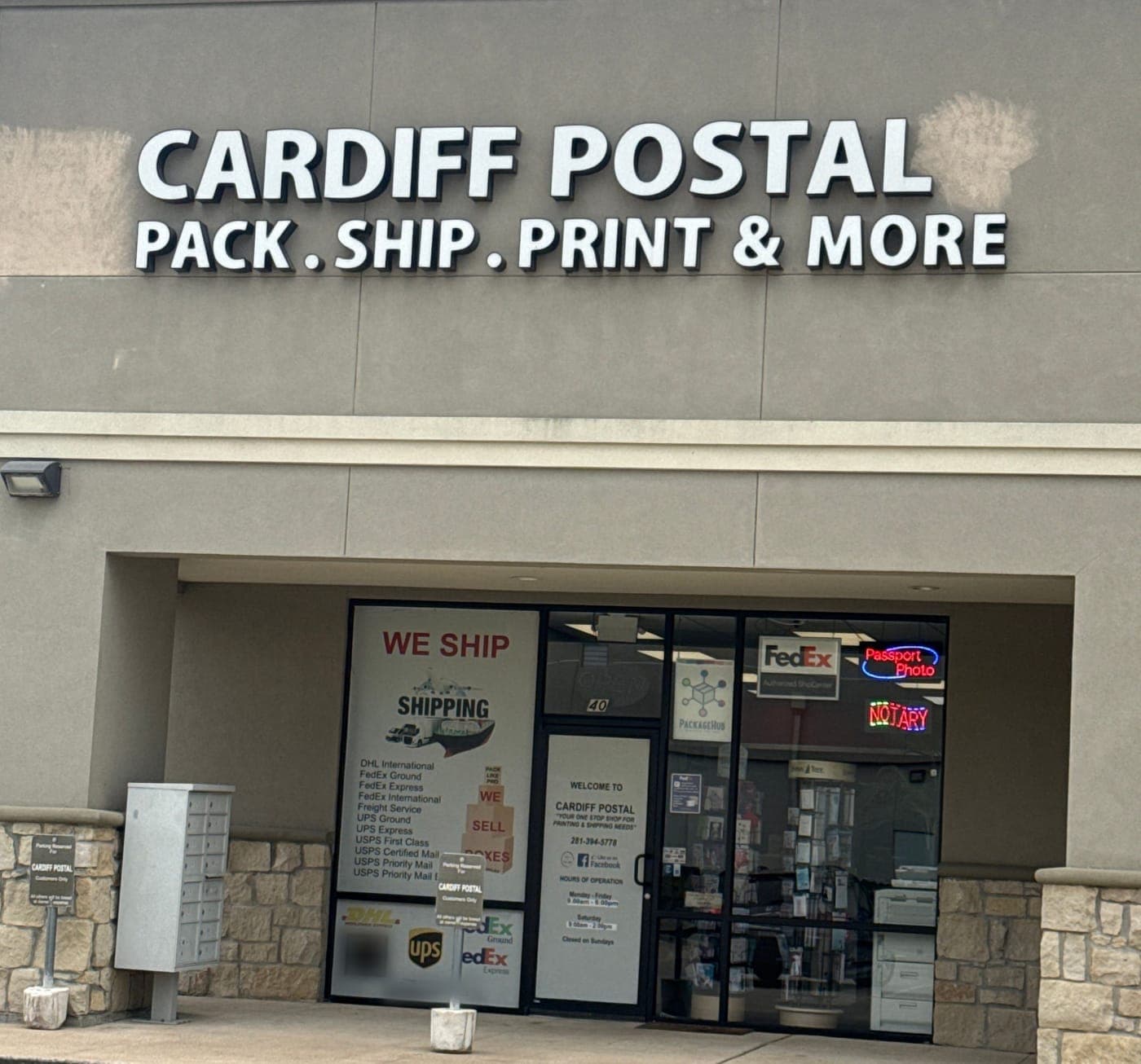The Cardiff Postal sign, Pack . Ship . Print & More, above the store entrance