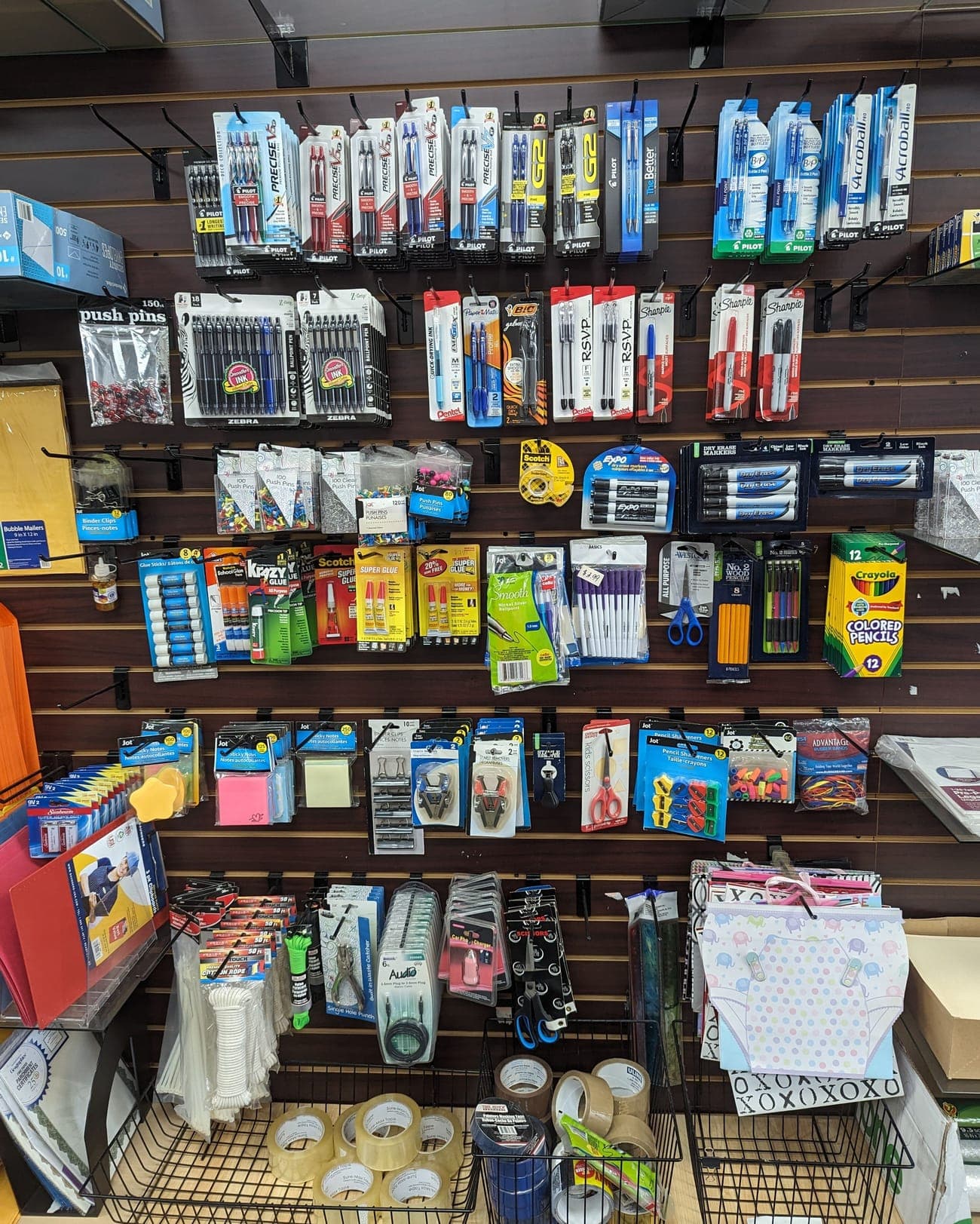Pegboard of pens, markers, packing tape and bubble mailers for sale